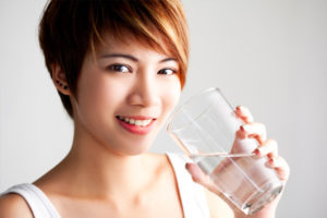 woman-drinking-tall-glass-of-water