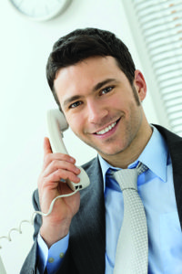 Happy young businessman talking on landline phone at office, smiling. Click here for more Business images: [url=my_lightbox_contents.php?lightboxID=1500413][img]http://www.nitorphoto.com/istocklightbox/businesspeople.jpg[/img][/url] [url=my_lightbox_contents.php?lightboxID=3209528][img]http://www.nitorphoto.com/istocklightbox/beigebusiness.jpg[/img][/url] [url=my_lightbox_contents.php?lightboxID=1708462][img]http://www.nitorphoto.com/istocklightbox/womeninbusiness.jpg[/img][/url] [url=my_lightbox_contents.php?lightboxID=1800848][img]http://www.nitorphoto.com/istocklightbox/customerservice.jpg[/img][/url] [url=my_lightbox_contents.php?lightboxID=5638799][img]http://www.nitorphoto.com/istocklightbox/szendi.jpg[/img][/url]