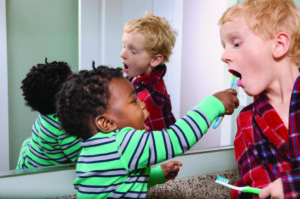 brothers brushing teeth